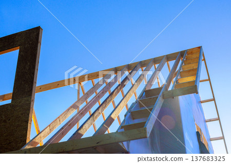 Construction workers build house frame under prepare for building 137683325