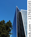 A futuristic office building against a blue sky 137683585