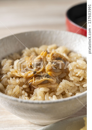 Clam rice cooked in a bowl; a classic Japanese dish with the delicious flavor of dashi broth infused into the rice. Clam rice cooked in a bowl; a classic Japanese dish with the delicious flavor of dashi broth infused into the rice. 137683991