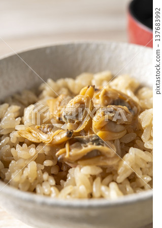 Clam rice cooked in a bowl; a classic Japanese dish with the delicious flavor of dashi broth infused into the rice. Clam rice cooked in a bowl; a classic Japanese dish with the delicious flavor of dashi broth infused into the rice. 137683992