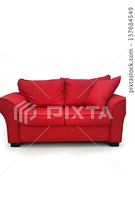 Red couch with two pillows on it 137684549