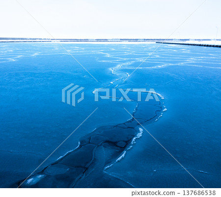 The frozen landscape of Yubetsu Fishing Port in the Okhotsk region of Hokkaido in the middle of winter. The frozen landscape of Yubetsu Fishing Port in the Okhotsk region of Hokkaido in the middle of winter. 137686538