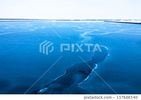 The frozen landscape of Yubetsu Fishing Port in the Okhotsk region of Hokkaido in the middle of winter. The frozen landscape of Yubetsu Fishing Port in the Okhotsk region of Hokkaido in the middle of winter. 137686540