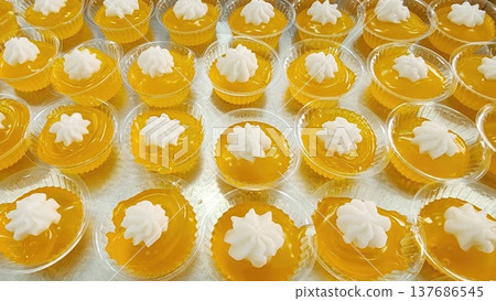 Delicious Orange Jelly Cups with Creamy White Coconut Topping - Traditional Thai Dessert Delicious Orange Jelly Cups with Creamy White Coconut Topping - Traditional Thai Dessert 137686545