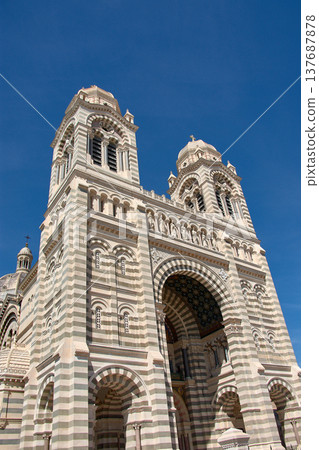 Domes and towers of the Marseille Cathedral of Sainte-Marie-Majeure in the La Joliette district, neo-Byzantine architecture under a blue sky Domes and towers of the Marseille Cathedral of Sainte-Marie-Majeure in the La Joliette district, neo-Byzantine architecture under a blue sky 137687878