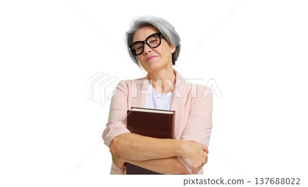 Confident mature woman holding book smiling Confident mature woman holding book smiling 137688022