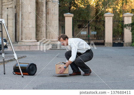 Astronomer Preparing Telescope Equipment On Paved Street 137688411