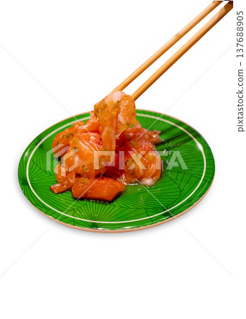 Top view of Raw Salmon salad Sashimi with chopsticks on green plate, focus selective Top view of Raw Salmon salad Sashimi with chopsticks on green plate, focus selective 137688905