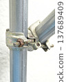 Close-up of scaffolding clamps and single pipes at a construction site (with rusted bolts). 137689409
