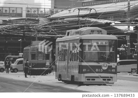 Hiroshima Electric Railway trains lined up in front of Yokogawa Station in a snowy landscape (monochrome) Hiroshima Electric Railway trains lined up in front of Yokogawa Station in a snowy landscape (monochrome) 137689433