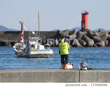 Fishing from the breakwater at the entrance to the fishing port Fishing from the breakwater at the entrance to the fishing port 137690090