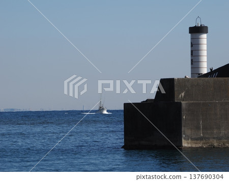 White lantern lighthouse and fishing boats at Odawara Fishing Port White lantern lighthouse and fishing boats at Odawara Fishing Port 137690304