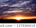 The rising sun over the mountain range and dramatic clouds 137690418