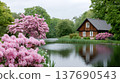 Wooden house by a pond with blooming pink rhododendrons 137690543