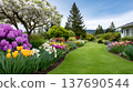 Spring garden with colorful blooming flowers and green lawn 137690544