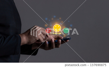 Customer Review, Young Man hand holding Smart Phone with five star to review and give 5 stars with very good results in service, Good review 5 star rating choice feedback 137690875