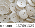 A lot of identical round white buttons 137691325