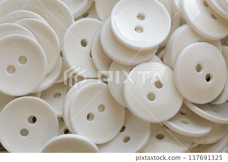 A lot of identical round white buttons 137691325