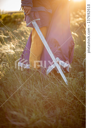 A woman and a man with a sword in medieval costume. Vertical photo 137692618