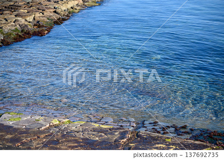 The clear blue sea and the seawall 137692735