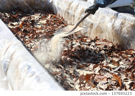 A man making a stepping hotbed 137693223