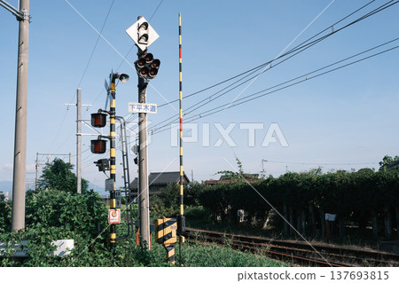 A summer scene with a nostalgic railway crossing. 137693815