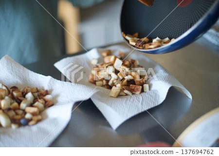 I'm transferring the toasted bread crusts to a plate. I'm transferring the toasted bread crusts to a plate. 137694762