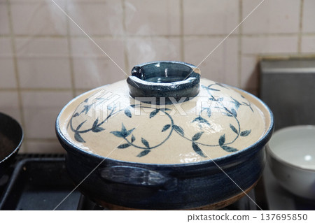 Cooking rice in a clay pot Cooking rice in a clay pot 137695850