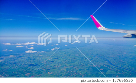 Aftersunset sky, bright blue, dotted with soft white clouds Aftersunset sky, bright blue, dotted with soft white clouds 137696530