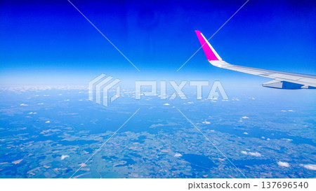 Aftersunset sky, bright blue, dotted with soft white clouds Aftersunset sky, bright blue, dotted with soft white clouds 137696540