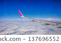 Plane wing glides above fluffy white clouds 137696552