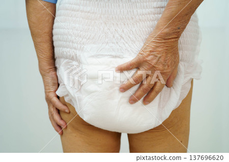 Asian senior woman patient wearing adult incontinence diaper pad in hospital. 137696620