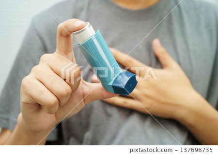 Asthma and chronic obstructive pulmonary disease COPD, Asian teenage using metered dose inhaler MDI. Asthma and chronic obstructive pulmonary disease COPD, Asian teenage using metered dose inhaler MDI. 137696735