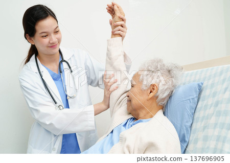 Asian doctor checking and treat elderly woman patient health in hospital. Asian doctor checking and treat elderly woman patient health in hospital. 137696905
