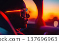Futuristic Driver Wearing Neon Light Glasses at Sunset 137696963