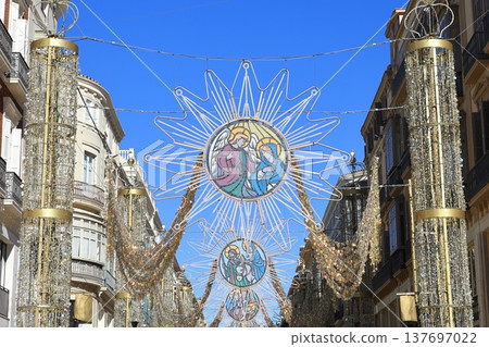Malaga Christmas Decorations.  A view of Christmas decorations draped across a street in Malaga, Spain. 137697022