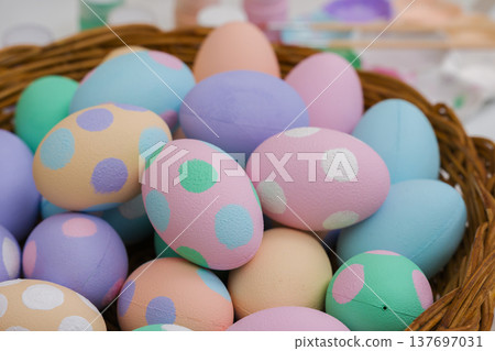many colorful pastel decorated easter eggs in small wooden basket and watercolor painting tool many colorful pastel decorated easter eggs in small wooden basket and watercolor painting tool 137697031
