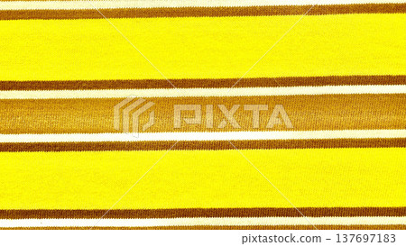 vibrant yellow brown striped knit fabric closeup texture with warm autumn tones for cozy wallpaper or design background vibrant yellow brown striped knit fabric closeup texture with warm autumn tones for cozy wallpaper or design background 137697183