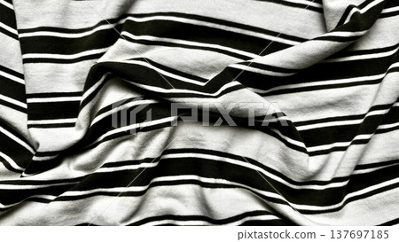 crumpled black white striped fabric folds in dramatic monochrome closeup texture for minimalist wallpaper or design background crumpled black white striped fabric folds in dramatic monochrome closeup texture for minimalist wallpaper or design background 137697185