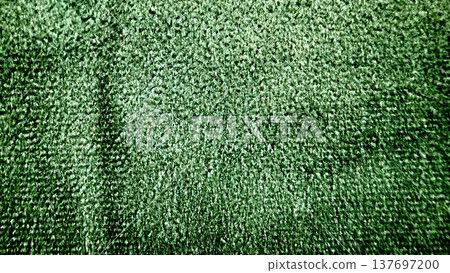 emerald green velvety texture closeup revealing soft fibrous pile and subtle folds for abstract wallpaper or design background 137697200