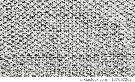 closeup grayscale knit texture with intricate yarn loops evoking cozy warmth ideal for seamless wallpaper or subtle banner background closeup grayscale knit texture with intricate yarn loops evoking cozy warmth ideal for seamless wallpaper or subtle banner background 137697202