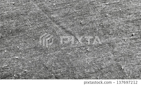 grayscale closeup of intricate knit fabric texture showcasing fibrous weave and subtle patterns ideal for seamless wallpaper or design background 137697212