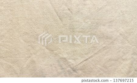 closeup wrinkled beige canvas fabric texture evoking rustic simplicity for minimalist wallpaper or copy space banner closeup wrinkled beige canvas fabric texture evoking rustic simplicity for minimalist wallpaper or copy space banner 137697215