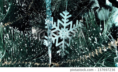 glistening snowflake ornament on frosted christmas tree branch for holiday card design glistening snowflake ornament on frosted christmas tree branch for holiday card design 137697236
