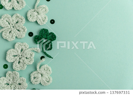 Crocheted Four Leaf Clovers with Sequins.  Saint Patricks Day Decorative Background 137697331