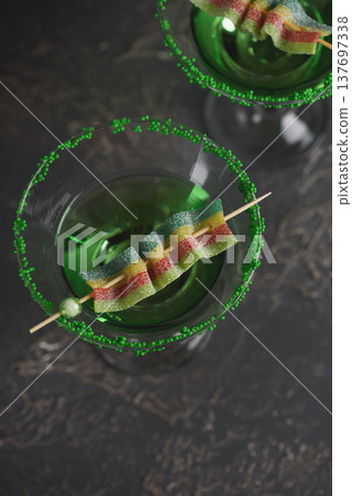 Green Cocktails with Rainbow Candy and Shamrocks. Festive St. Patricks Day Celebration Still Life 137697338