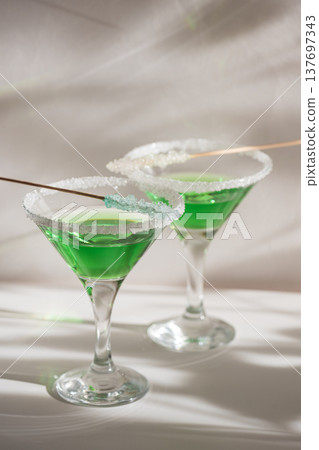 Green Martini Cocktails with Rock Candy. Festive St. Patricks Day Celebration Still Life Green Martini Cocktails with Rock Candy. Festive St. Patricks Day Celebration Still Life 137697343