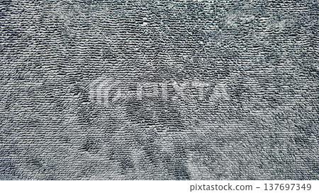 abstract gray microfiber towel fabric texture with soft looped pile and subtle shadows, neutral textile background for web design, print media, branding, packaging, and surface pattern use 137697349