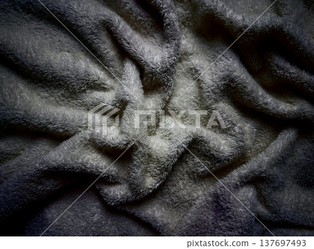 abstract gray fuzzy blanket texture with intricate folds and soft shadows evoking cozy serenity for wallpaper or design background 137697493