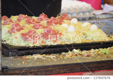 Festival stalls: Okonomiyaki made with fresh vegetables Festival stalls: Okonomiyaki made with fresh vegetables 137697676
